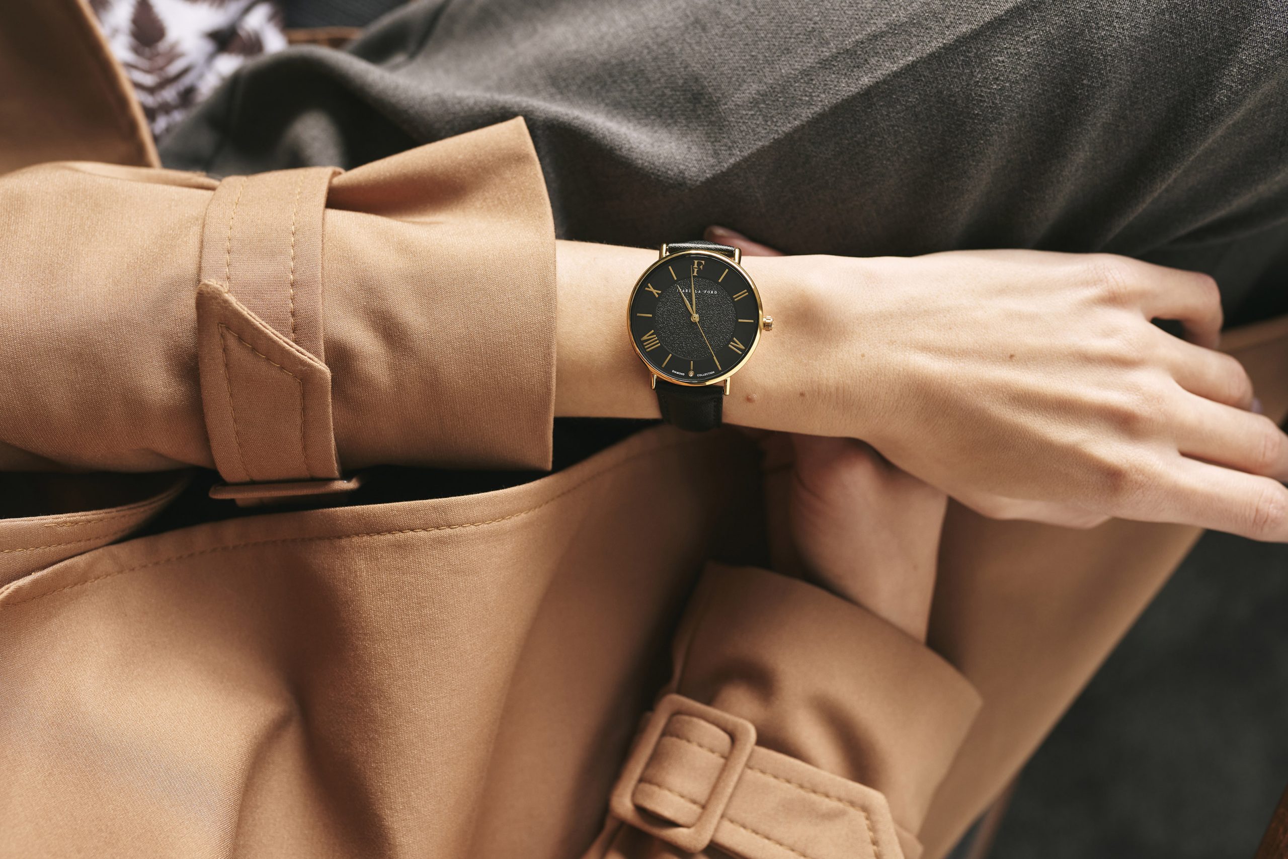 A black watch in gold case with black leather bracelet
